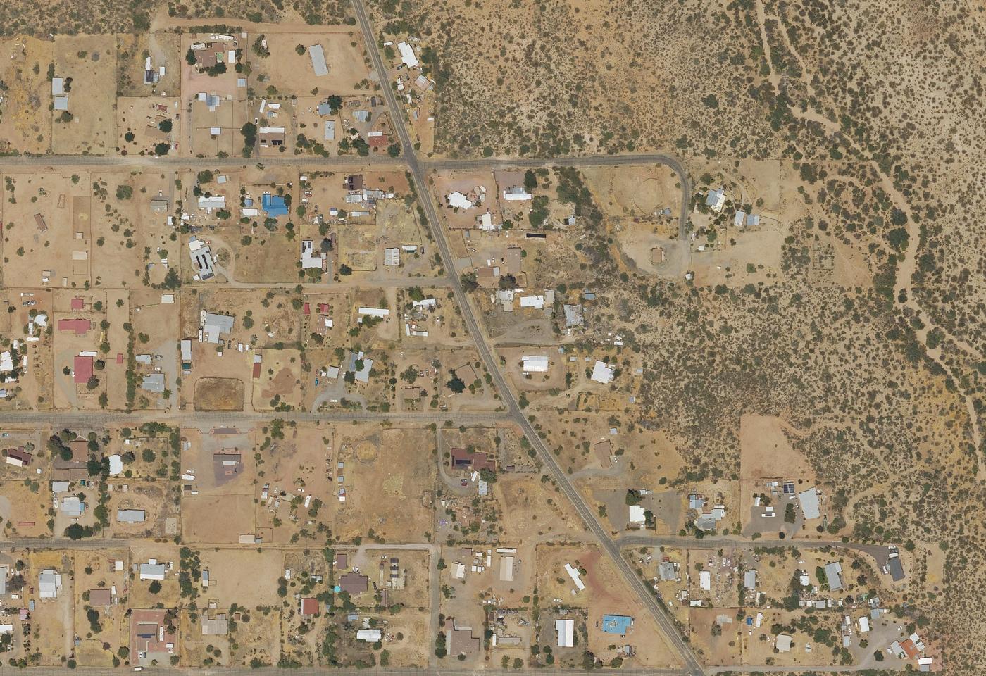 The Ghost Town Road neighborhood in Congress from above, lots of an acre or more along a paved road with open desert beyond